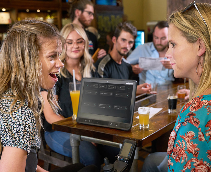 Woman using TD I-16 device with friends