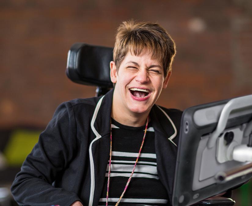 Woman using Tobii Dynavox SC Tablet speech generating device to communicate